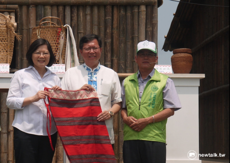 「原民造屋」工作人員贈送原住民傳統服飾給蔡英文總統。   圖：鍾孟軒/攝