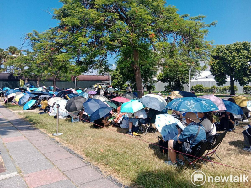 演唱會搖滾區入口外草地一片傘海。   圖：孫家銘/攝