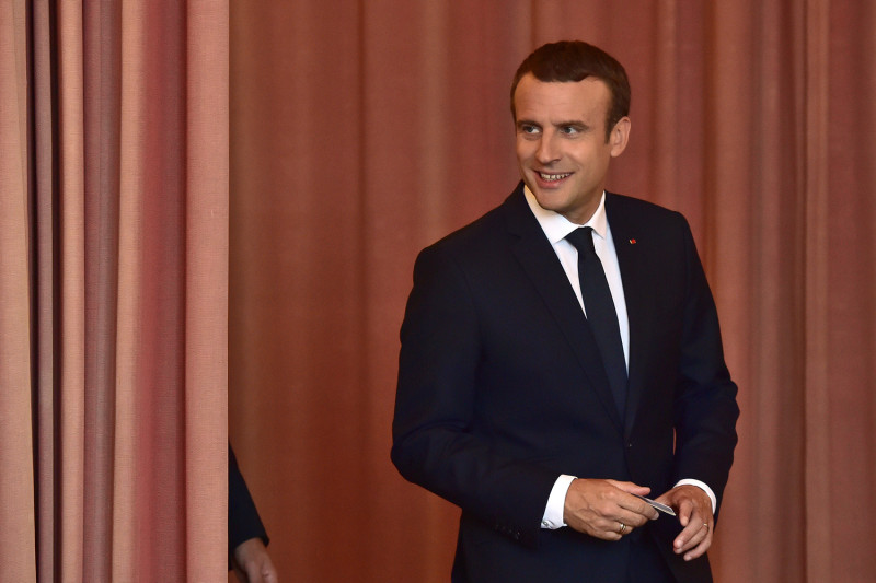 法國國會第2輪選舉，總統馬克宏18日圈選心中理想的候選人後，面帶微笑走出帷幕，顯示對選舉有相當信心。   圖：達志影像/路透社