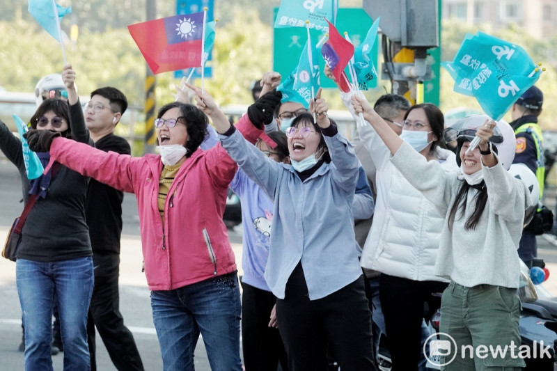 年輕的支持者手舉著國旗和柯的競選旗幟，站在路旁向柯加油打氣。   圖：張良一/攝