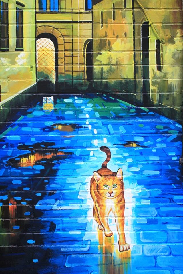 雲林頂溪社區內的貓咪彩繪，其實是紀念原來生活在當地的小流浪貓小咪   圖：頂溪社區屋頂上的貓提供