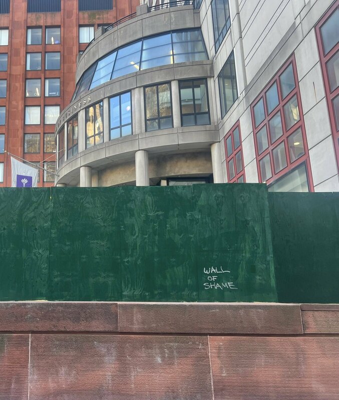 紐約大學充滿了被漆成綠色的木板所構築的圍牆，有些木板還寫著「羞恥之壁」。   圖：翻攝自方舟子 X（前推特）帳號