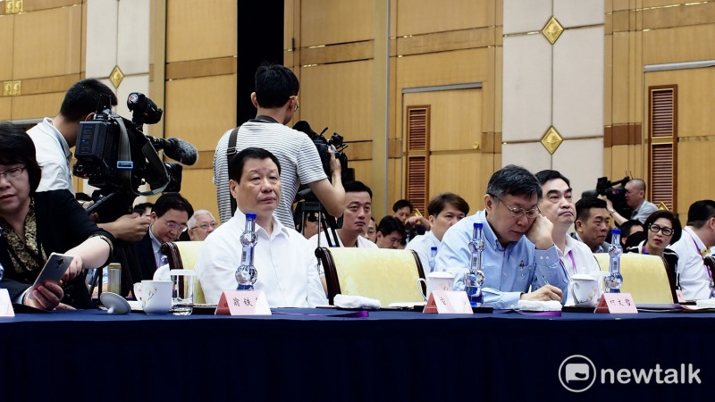 聆聽演講時，上海市長應勇（左）坐姿往後傾，台北市長柯文哲（右）則拿著筆向前傾在做筆記。   圖 : 周煊惠／攝