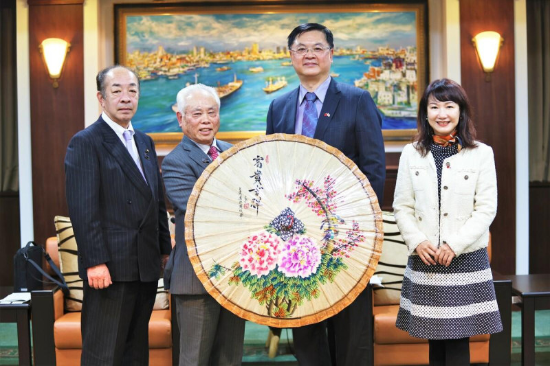 羅達生(右二)致贈高雄美濃油紙傘予武藤鉄弘(左二)、山口育男(左一)，期盼深化雙邊文化工藝交流合作。   圖：高雄市行國處提供