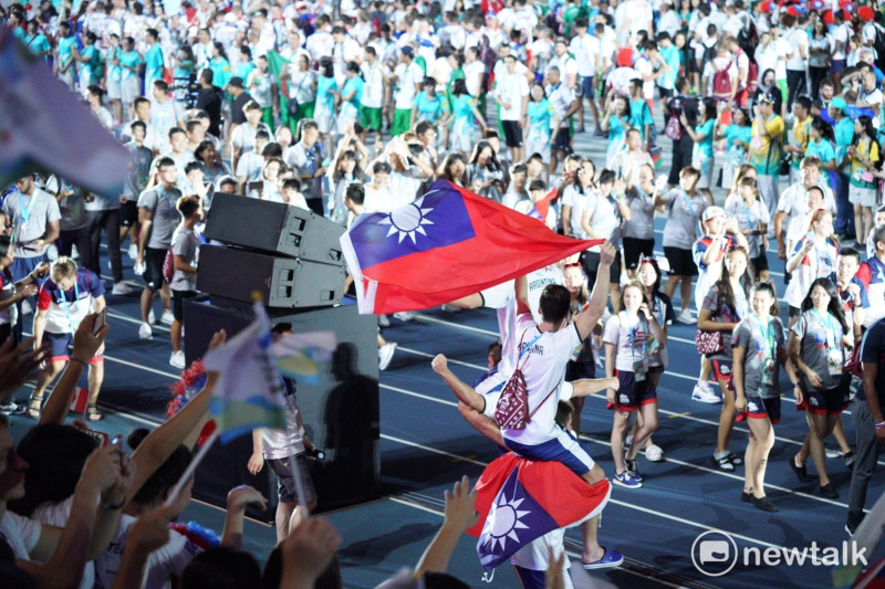 國旗與國旗帽由外國選手攜帶進世大運閉幕典禮。   圖：常日豪/攝