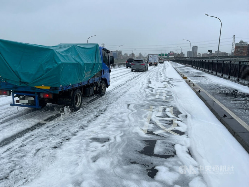 陳姓男子29日駕駛小貨車行經華江橋時發生車禍,導致車上載運的洗潔劑、漂白水等清潔用品掉落,造成大量泡沫擴散,影響行車安全;現場於中午清除完畢,解除交通管制。(翻攝畫面)中央社記者黃旭昇新北市傳真 114年5月29日