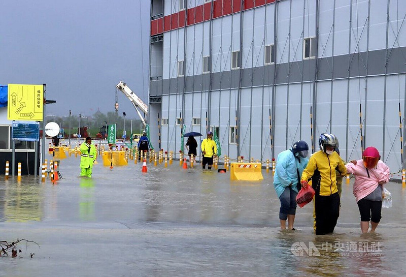 受低壓帶與西南風影響，嘉義縣28日清晨起降豪大雨，位於嘉義科學園區興建中的台積電先進封裝廠工地淹水，員工涉水通行。   圖：中央社
