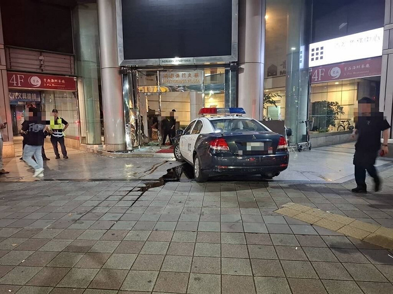 台北市大安警分局員警7日凌晨開警用汽車赴忠孝東路4段附近大樓處理糾紛案時，疑煞車失靈，車輛直衝大樓撞擊門柱後才停住，導致大門玻璃破碎，造成2名民眾雙腿被玻璃割傷。（警方提供）中央社記者劉建邦傳真　114年8月7日   