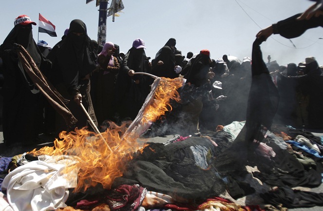 數百名葉門婦女放火燃燒一堆傳統面紗，抗議政府殘忍鎮壓人民抗爭。照片來源：美聯社/達志影像   