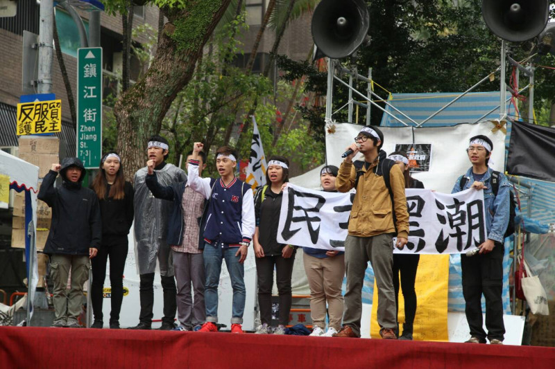 約10位民主黑潮的學生今（7）天早上在青島東路的舞台，邀請各界和他們一起向立委施壓反服貿。圖：林雨佑/攝   