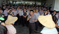 麥寮六輕工業區台塑石化煉油廠，7月間2度火警，引發麥寮居民不滿，居民26日前往台塑麥寮管理部大樓抗議，民眾和戒備的警力對峙。圖片提供：中央社   