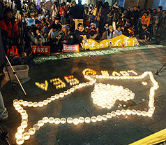 全國青年反國光石化聯盟26日晚上在環保署前舉行「燭光守夜」活動，呼籲撤銷國光石化開發案。圖片來源：中央社   